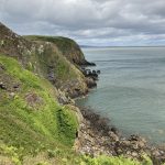 Cliffs with vegetation in Balcary. Outdoors nature walk on the Solway firth.